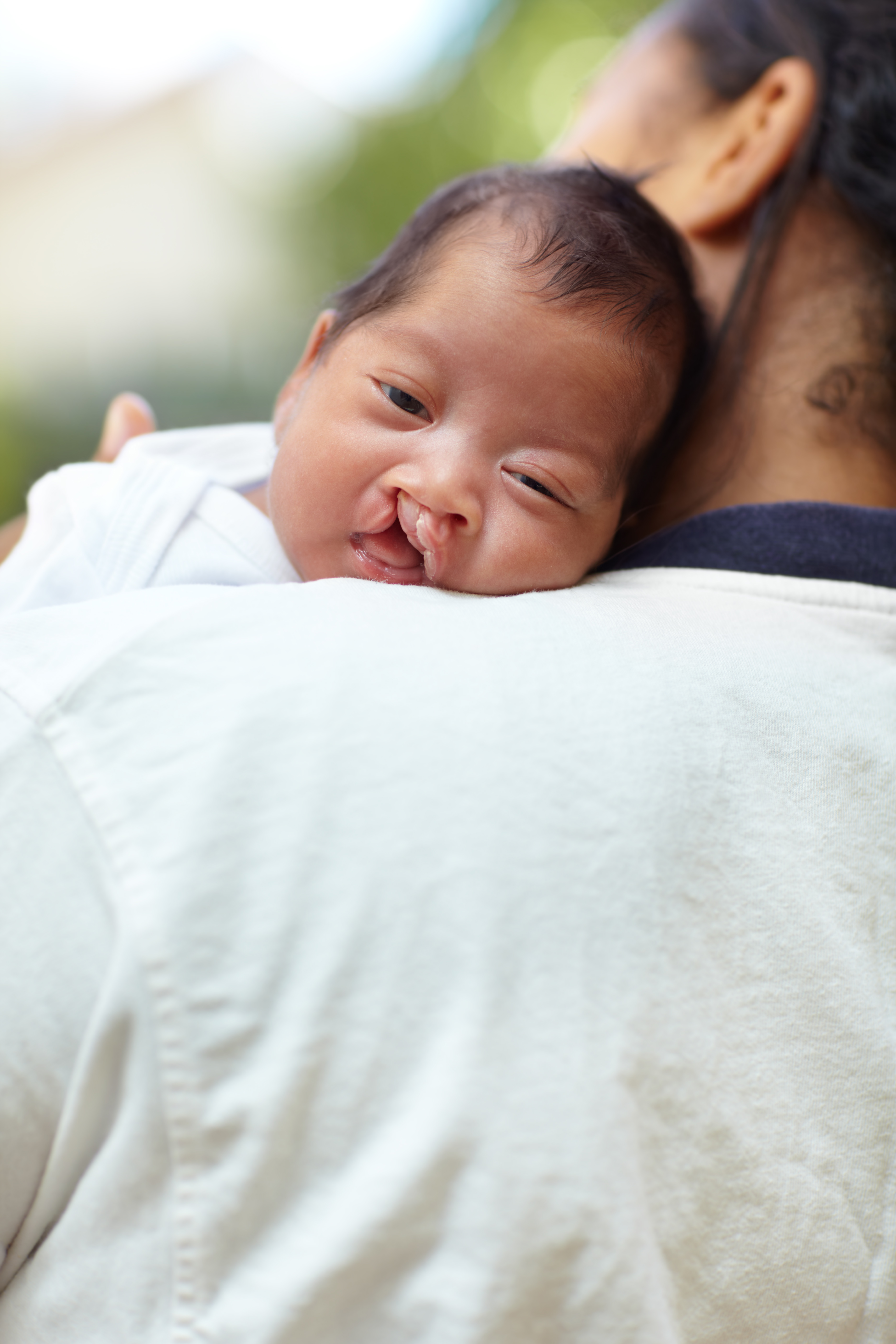 newborn carried by mother