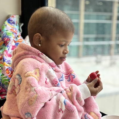 child cancer patient eating strawberry