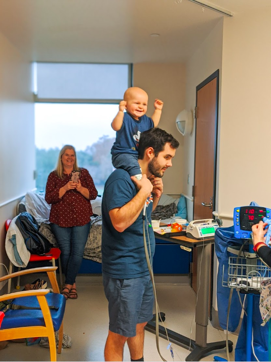 Charlie on father's shoulders smiling