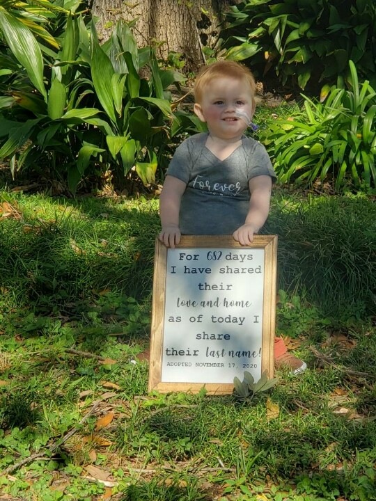 Jaxon holding a sign outside