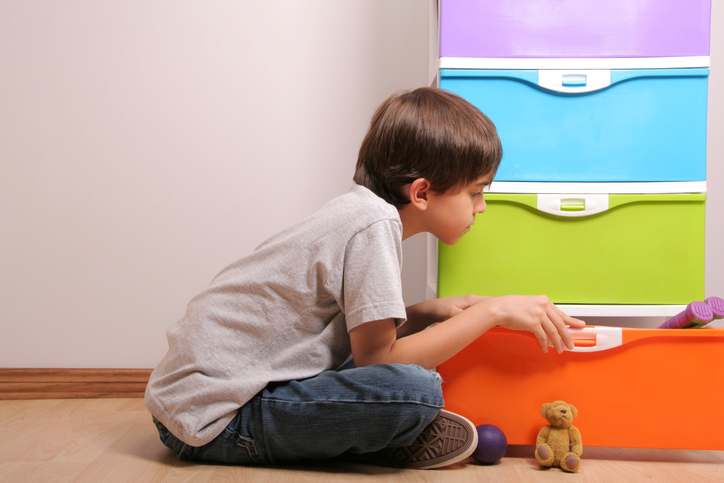 boy next to storage bins