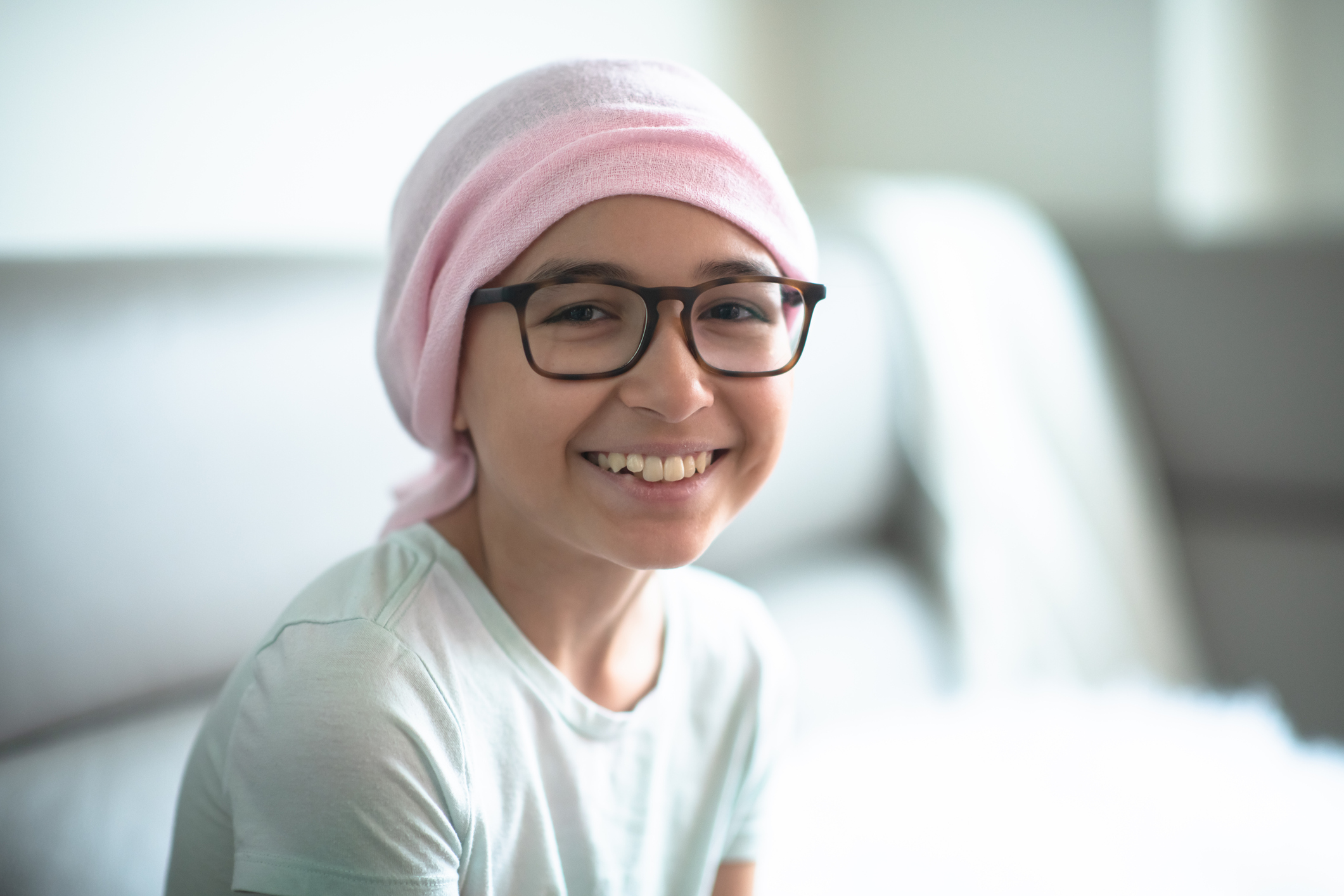 young girl smiling sitting on a chair