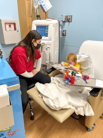 provider with child patient doing creative activities on his board