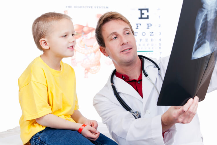 physician showing child x-rays