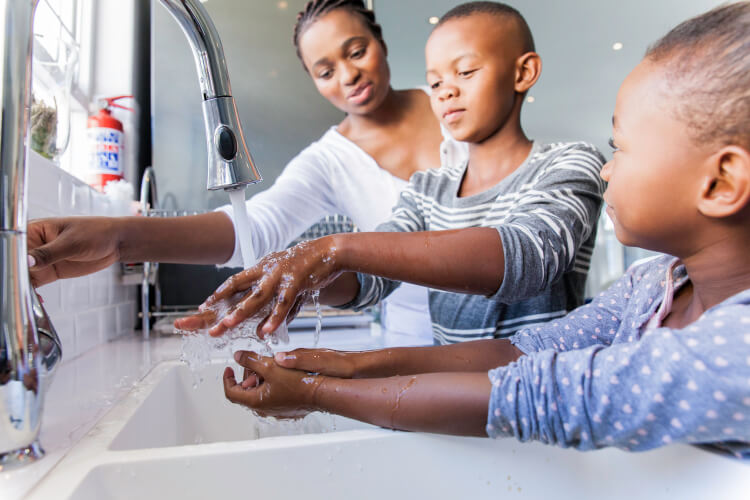 Family washing their hands together.