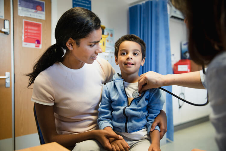 young child being checked out my physician 