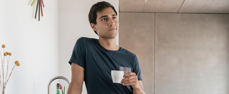 Man thinking in kitchen.